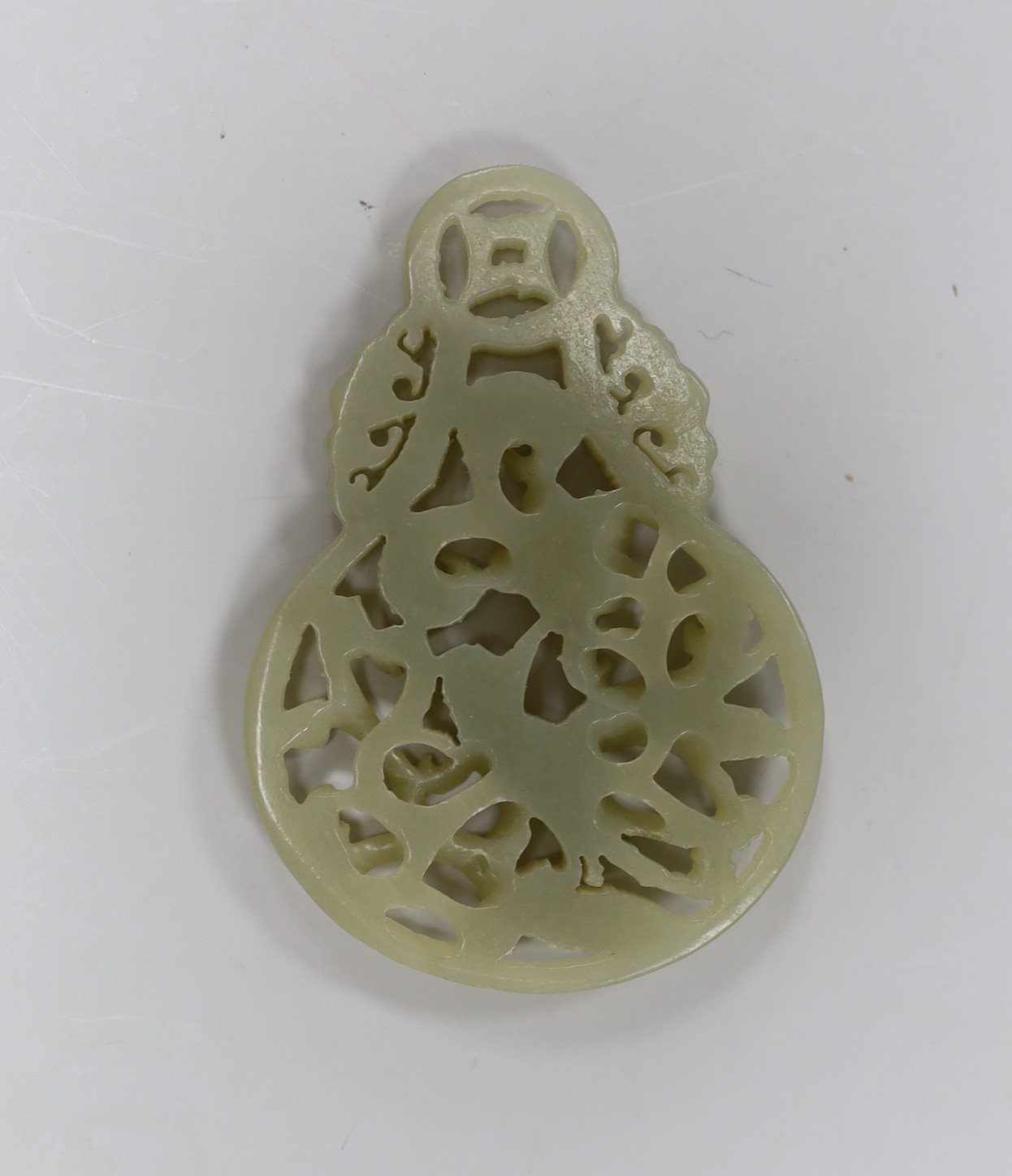 A Chinese celadon jade reticulated pendant. 7cm tall